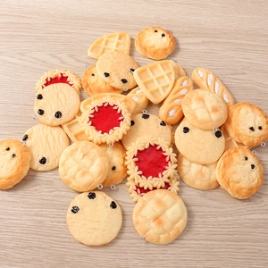 Detailed close-up of mixed realistic resin food charms on a light wood background