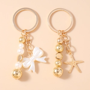 Porte-clés en Alliage de Zinc Plaqué Or avec Künstliche Perles d'Imitation Nœud et Étoile de Mer Bijou de Sac Pendentif pour Femme Bijoux