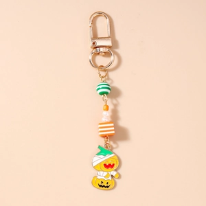 Detail of Halloween keychain with striped beads and mummy pumpkin enamel charm