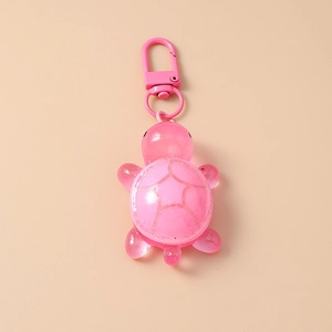 Detailed top view of pink translucent resin turtle keychain with pink metal lobster clasp