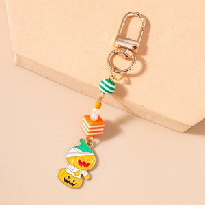 Macro shot of Halloween keychain with striped beads and mummy pumpkin enamel charm pendant