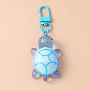 Detail of a 3D translucent blue turtle keychain with detailed shell patterns and metal clasp
