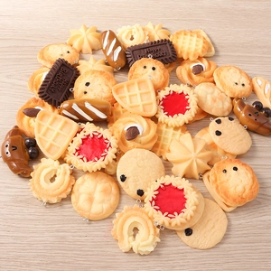 Detailed macro view of assorted resin food charms including waffles and chocolate biscuits