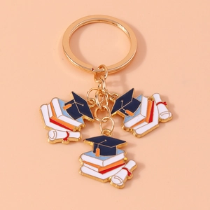 Gold-plated graduation keychain featuring navy blue doctoral cap and diploma scrolls
