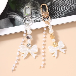 Y2K beaded keychain set with elegant pearls and resin bow pendants in gold and silver