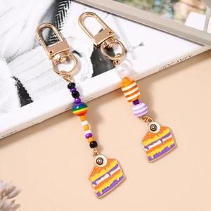 Colorful eye cake slice keychain with vibrant beads and lobster clasp on a stylish background