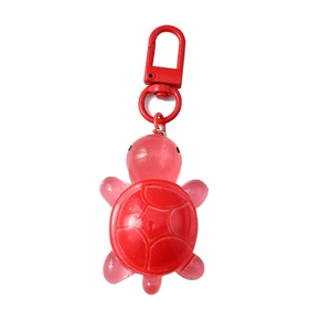 Translucent red resin turtle keychain with white patterns and matching metal spring clasp