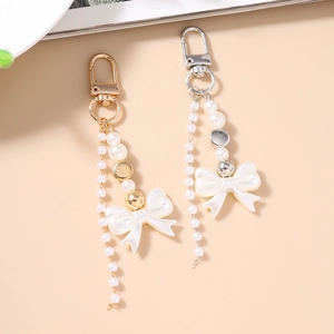 Sweet Y2K pearl bow keychain with hanging beads for bag decoration in gold and silver