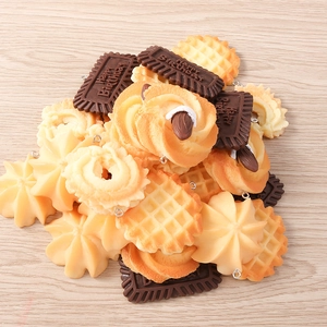Macro shot of resin dessert charms featuring chocolate, waffle and cookie designs with metal rings