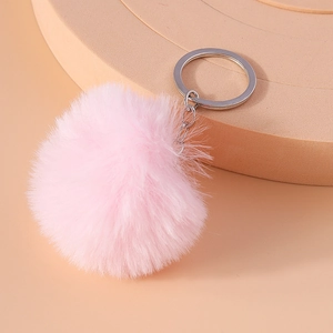 Close-up of soft pink 8cm faux fur pom-pom keychain with silver metal ring