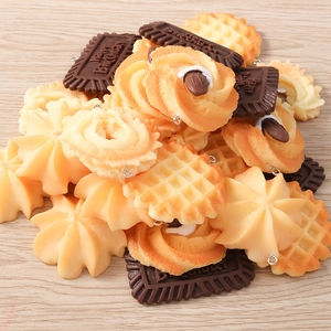 Macro shot of realistic food charms including cookies and waffles for DIY jewelry making