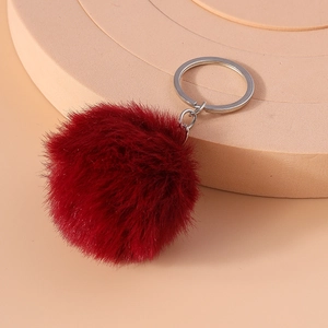 Detailed view of fluffy 8cm dark red faux fur pompom keychain with silver metal ring