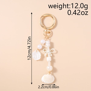 Detail van schelp sleutelhanger met parels en strik, 12cm lang, nautisch accessoire