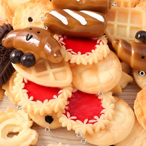Macro shot of realistic resin food charms like waffles and croissants for DIY jewelry