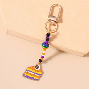 Detail of colorful beaded keychain with enamel eye cake charm and gold lobster clasp