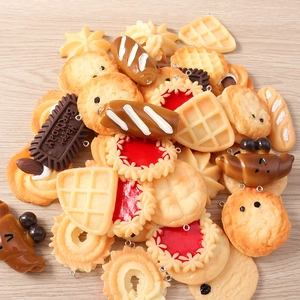 Detailed macro view of resin dessert charms featuring waffles and mini biscuits with metal hooks
