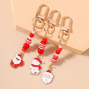 Detailed view of three festive Christmas keychains with snowman and Santa beaded charms