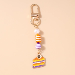 Detail of Halloween eye cake keychain with colorful enamel charm and beaded strap
