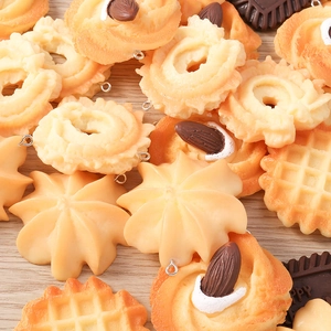 Macro detail of realistic resin food charms including waffles and cookies for jewelry making