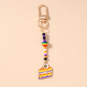 Detailed view of Halloween eyeball cake keychain with colorful beads and gold lobster clasp