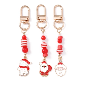 Three Christmas beaded keychains with Santa Claus and Snowman enamel charms in festive red and white