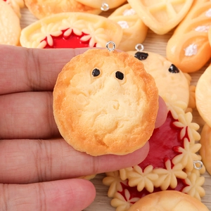 Detailed macro view of resin bread and cookie charms for DIY jewelry making accessories