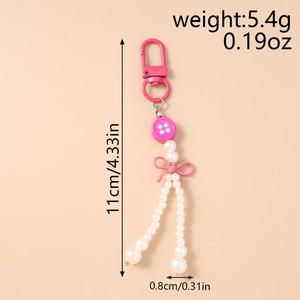 Porte-clés bouton rose avec perles, nœud et mousqueton D-ring, montrant une taille de 11 cm