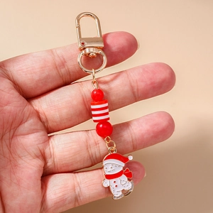 Detailed close-up of Christmas snowman keychain with red beads and enamel pendant
