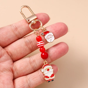 Porte-clés Père Noël festif avec perles rouges et blanches et fermoir mousqueton doré