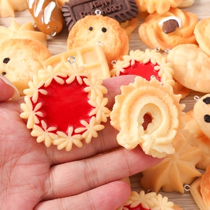 Macro shot showing detail of miniature jam cookie and chocolate waffle DIY jewelry pendants