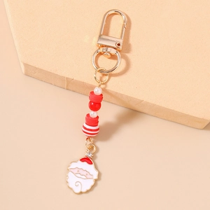 Detail of Christmas Santa keychain with red striped beads and golden metal ring