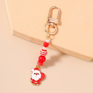 Detail of Santa Claus keychain with red and white beads and golden D-ring clasp