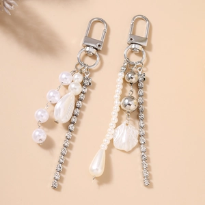 Detailed view of elegant pearl and rhinestone tassels for keychains and bag charms