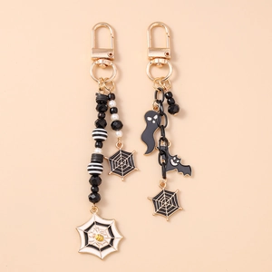 Halloween beaded keychain set with ghost, bat, and spider web charms in black and gold