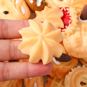 Macro-opname van realistische koekjesbedeltjes van hars tussen de vingers