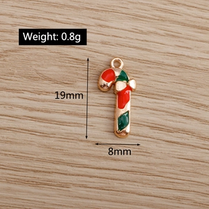 Macro detail of red and green enamel candy cane pendants with dimensions 19mm by 8mm