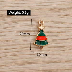 Detail of enamel Christmas tree charm with gold star and ring for jewelry making