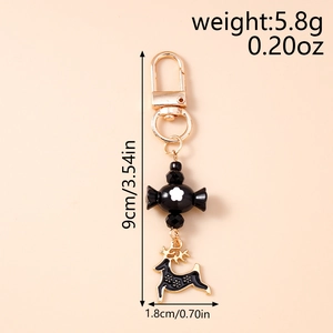 Detail view of black candy bead and reindeer pendant on a gold keychain hook