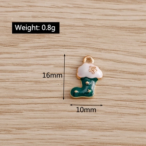 Detailed view of green enamel Christmas sock charm with dimensions of 16mm by 10mm