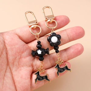 Black and gold flower candy keychain set with Christmas reindeer charms and golden hooks