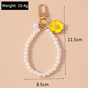 Detail of pearl keychain with yellow enamel flower, lobster clasp, and size markings