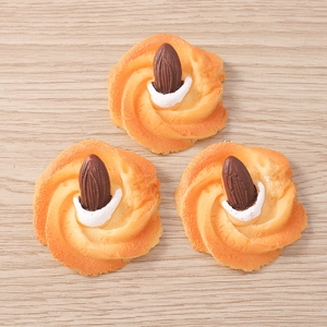 Macro detail of three resin almond biscuit charms with metallic rings for DIY jewelry making
