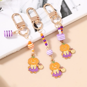 Porte-clés citrouille d'Halloween avec perles rayées colorées et fermoir doré élégant