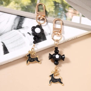 Creative Christmas reindeer keychain with flower and candy beads in black and white style