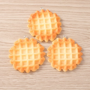 Macro detail of resin waffle charms with realistic texture and silver metal rings