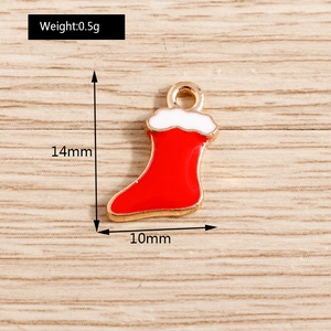 Macro detail of red and white Christmas sock pendant with dimensions 14mm by 10mm