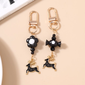 Detail view of a creative flower and candy keychain with black elk charm for bags