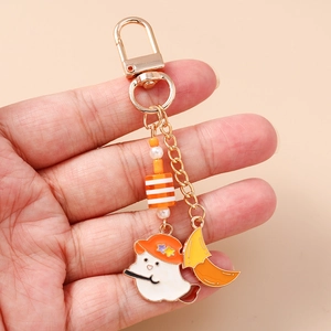 Detail of Halloween ghost keychain with orange wizard hat and decorative striped beads