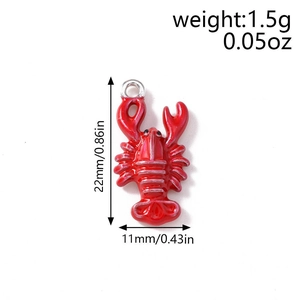 Macro detail of red lobster enamel charm with dimensions 22mm by 11mm and top silver ring