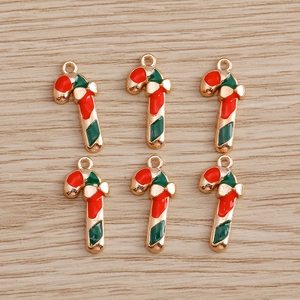 Detailed macro view of gold-plated enamel candy cane pendants for DIY jewelry making